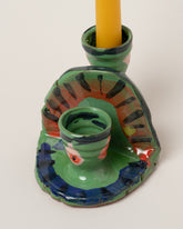 Closeup details of the Maggie Boyd Small Green Candle Holder on light color background.
