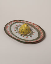 Closeup details of the Maggie Boyd Trompe LOL Lemon Platter on light color background.