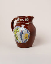 Closeup details of the Maggie Boyd Chocolate Dinner Plate Pitcher on light color background.