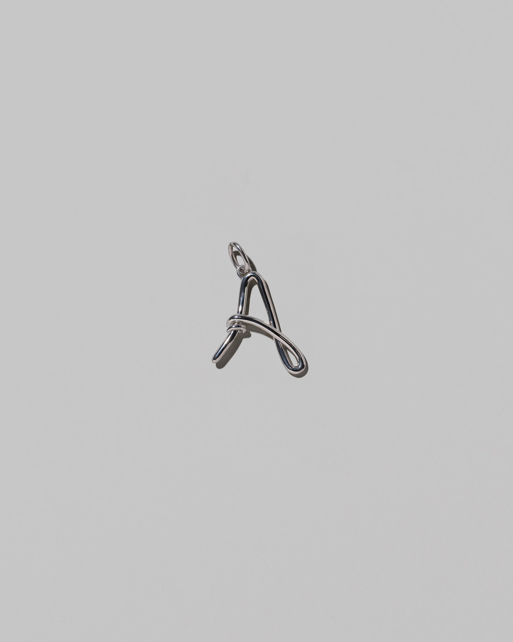 CRZM Medium Letter A Charm set in sterling silver on light color background.