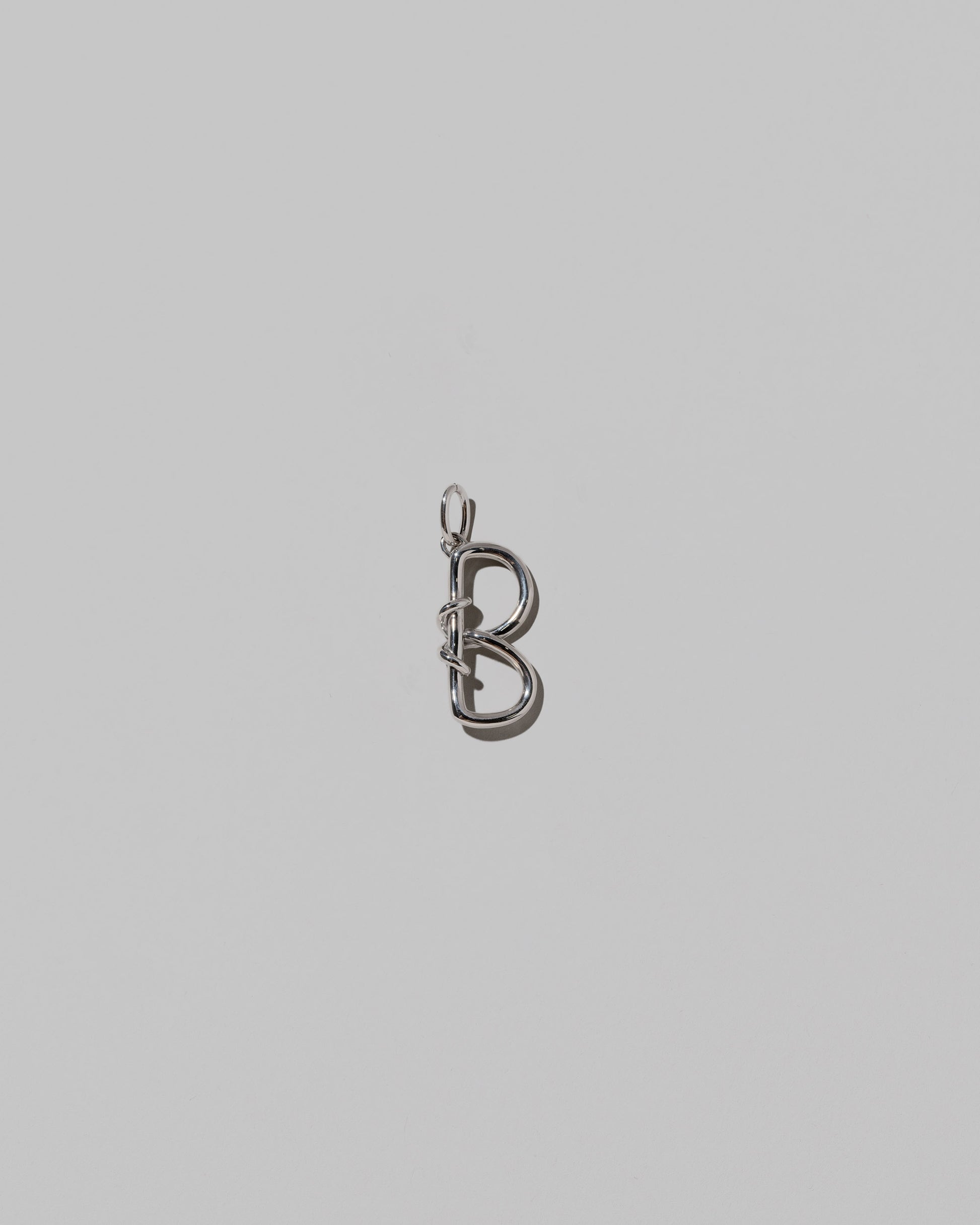 CRZM Medium Letter B Charm set in sterling silver on light color background.