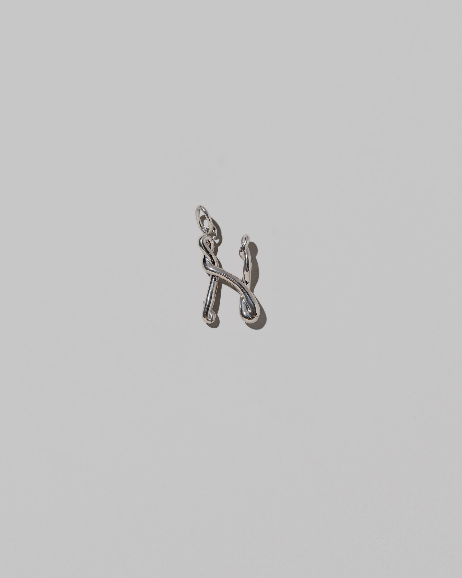 CRZM Medium Letter N Charm set in sterling silver on light color background.