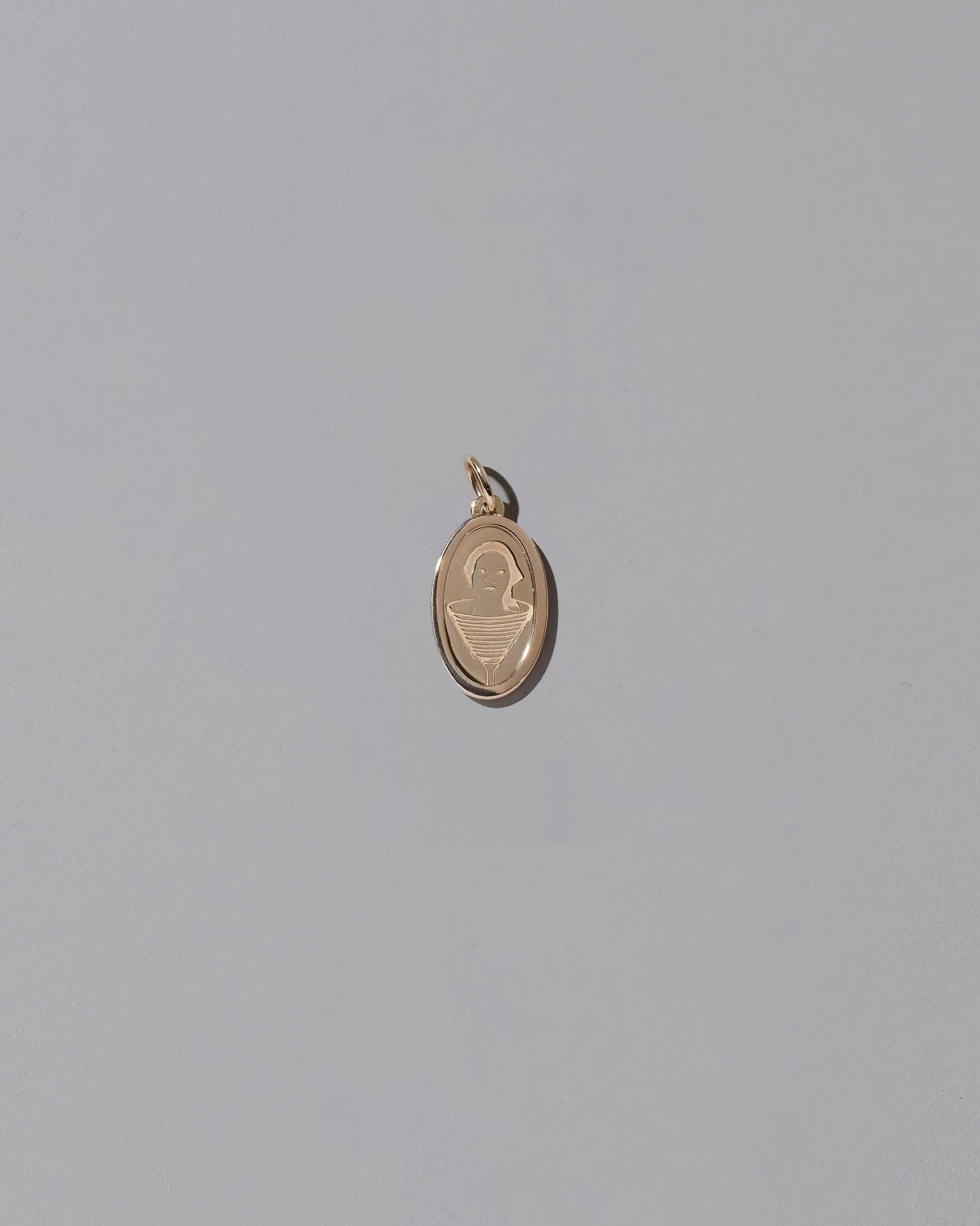 Finished Small Oval Memento Pendant on light color background.