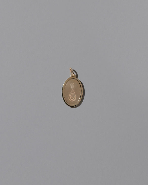 Finished Large Oval Memento Pendant on light color background.