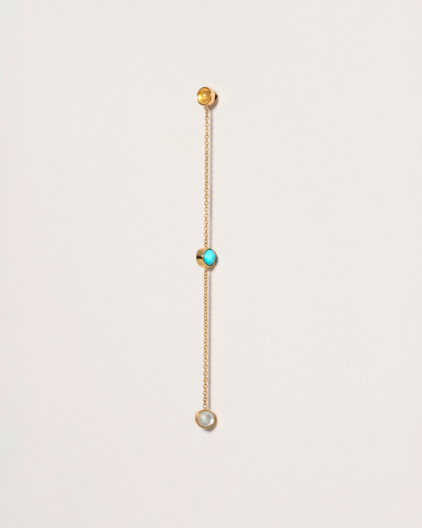 Birthstone Two-Drop Single Earring on light color background.