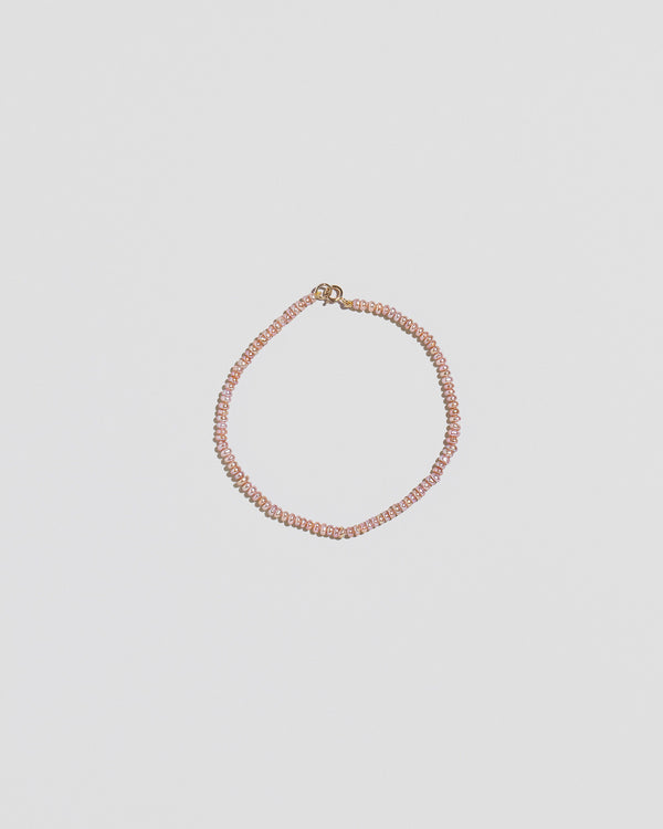 Pink Peony Lavender Seed Pearl Bracelet on light color background.