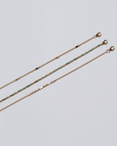 Closeup view of the White Diamond Consecutive, Emerald Full and Blue Sapphire Distributed style Building Blocks Bracelets Set on light color background.