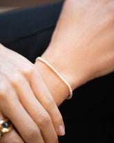 White Seed pearl bracelet on model.