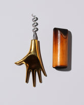 Detail view of the Carl Auböck Brass Hand Corkscrew on light color background.