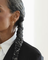 Styled image on model featuring the Infinity Styling Link on the Styling Huggie Hoop Earring Single.