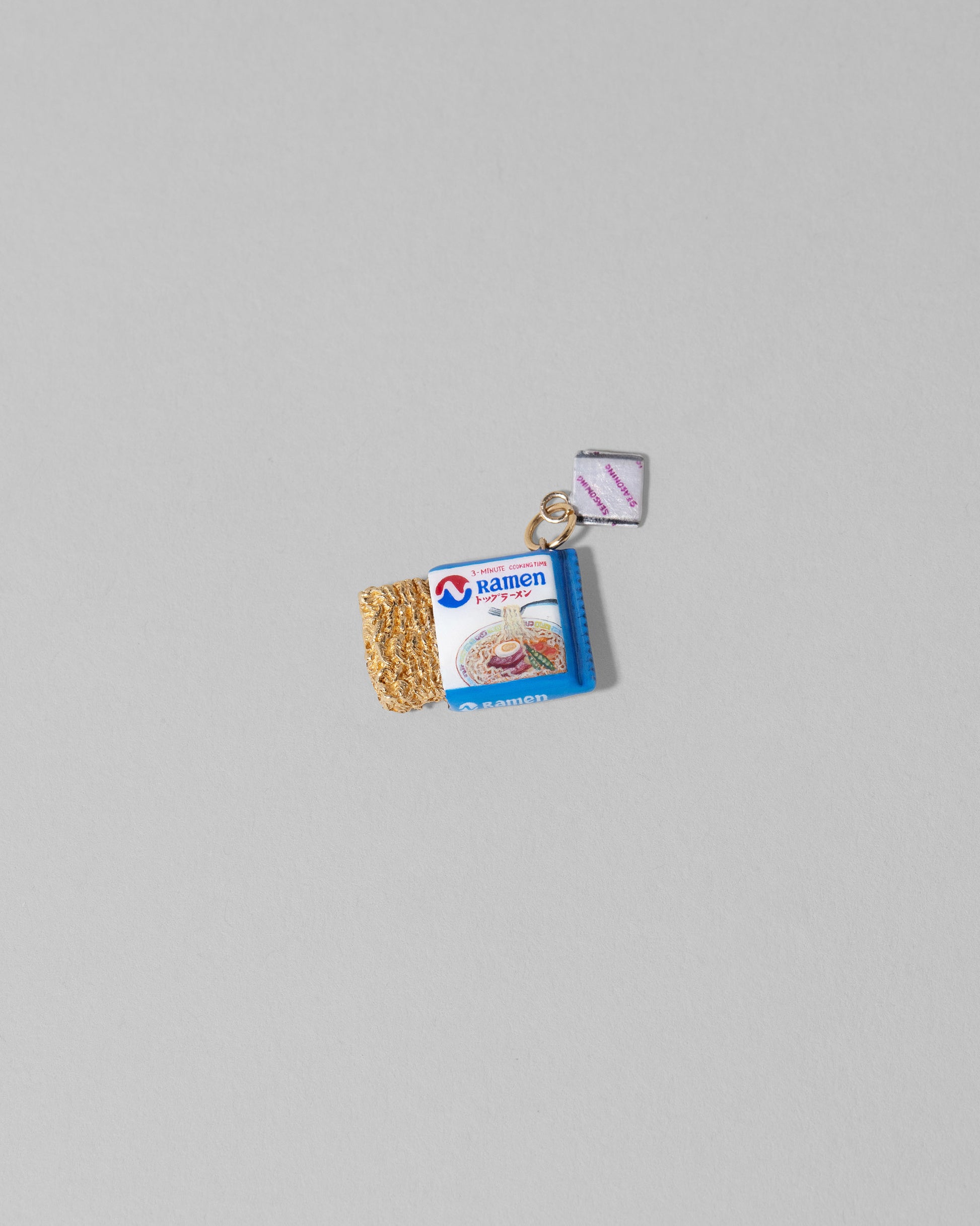 Instant Ramen Charm on light color background.