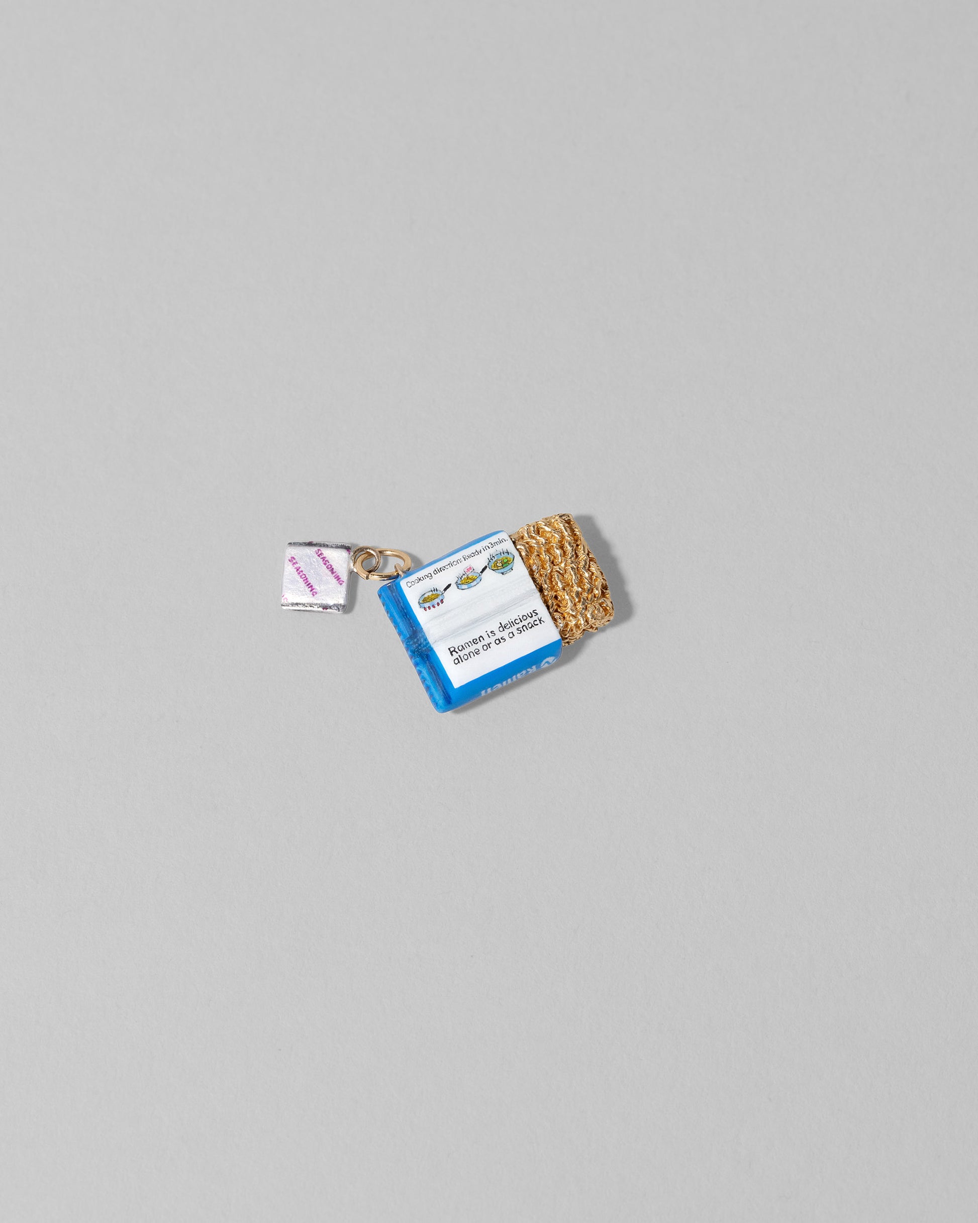 View from the back of the Instant Ramen Charm on light color background.