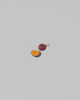 View from the back of the Passion Fruit Charm on light color background.