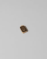 View from the back of the Sardine Can Charm on light color background.