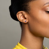 product_details::Sapphire Sun & Moon Stud earrings on model.