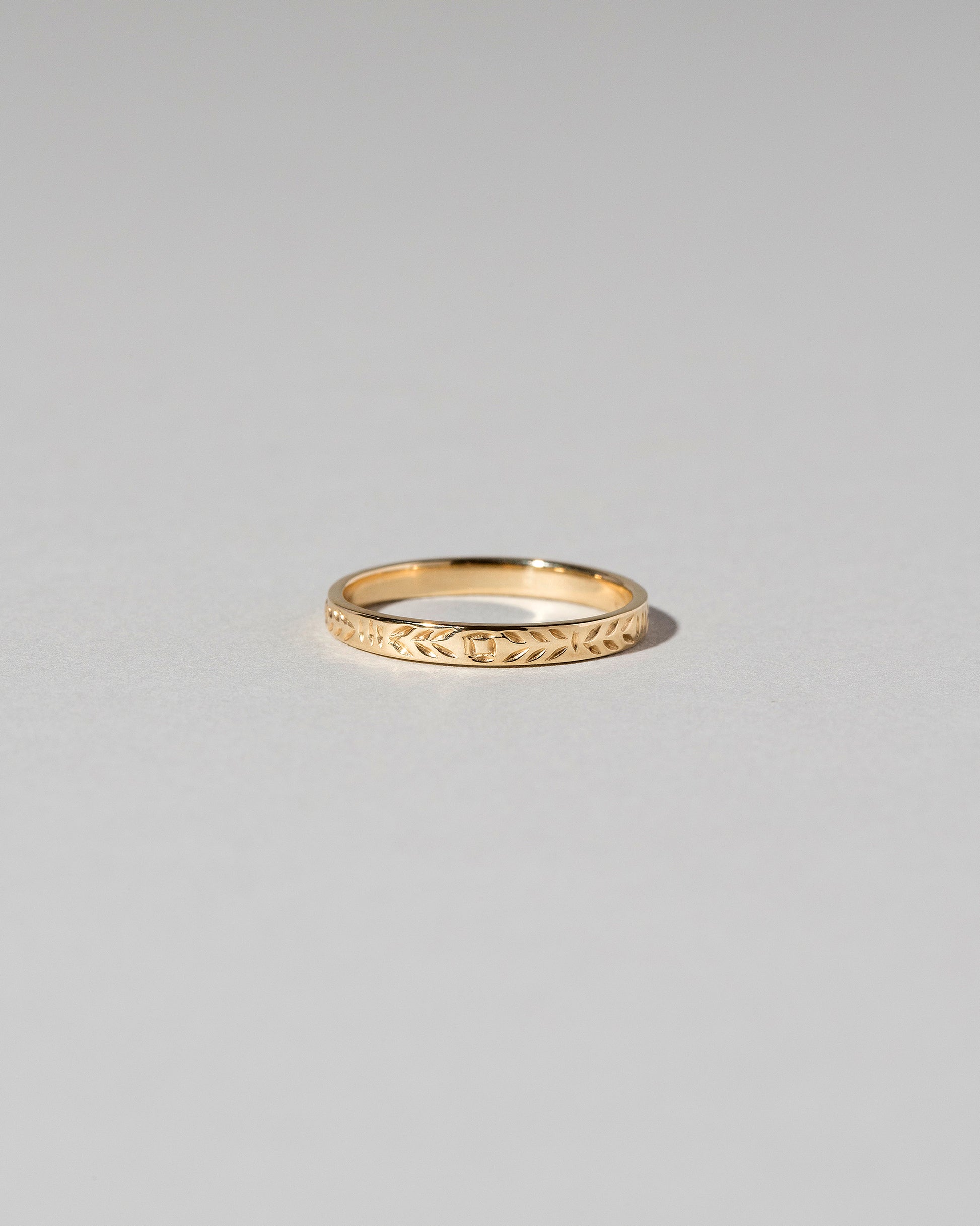 Gold 3mm Etched Leaf Band on light color background.