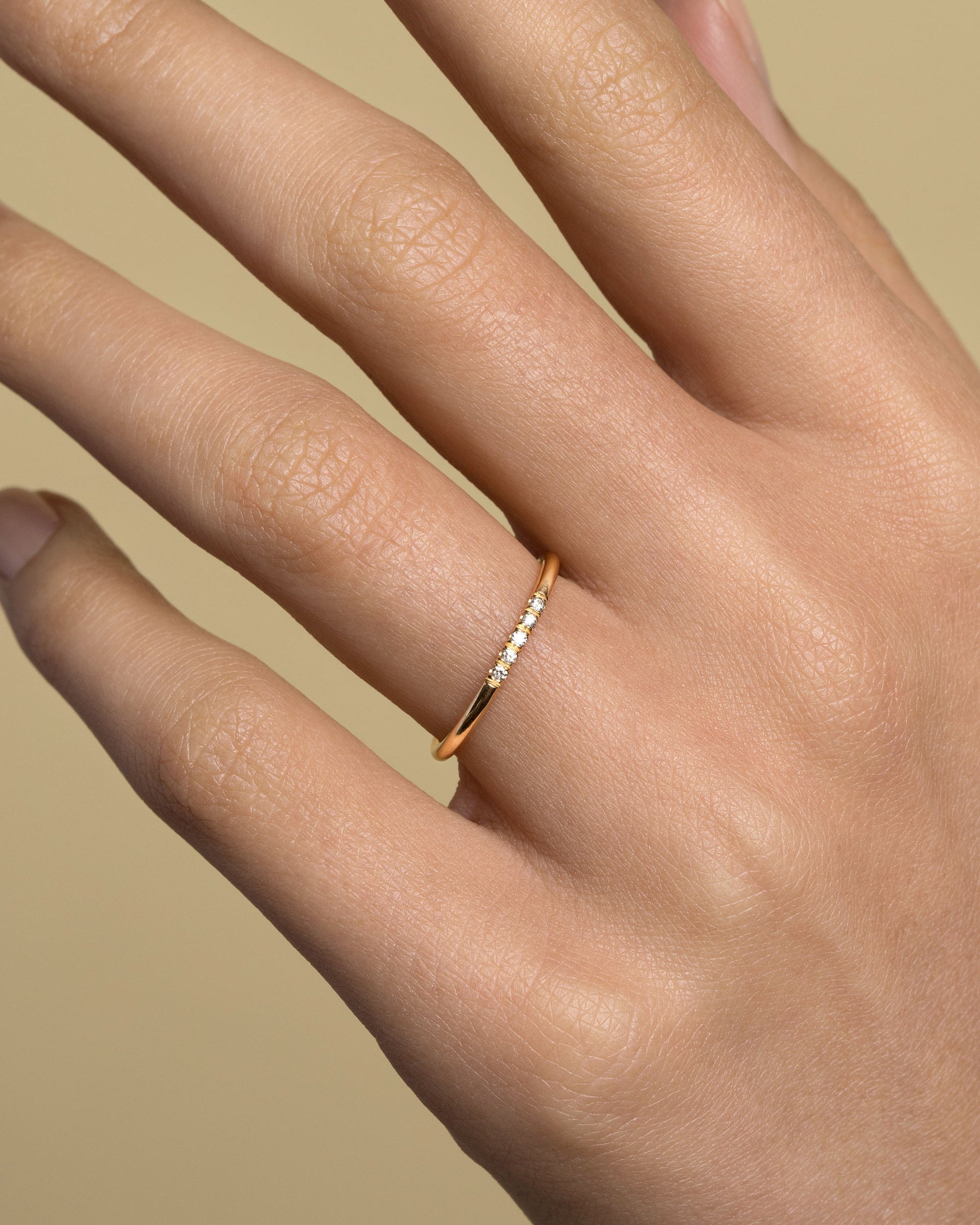 Gold Five Stone Dot Band on model.