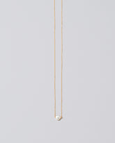 White Lagniappe Pearl Necklace on light color background.