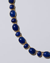 Closeup details of the Apparition Necklace on light color background.
