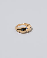 Closeup details of the Gold Blue Sapphire Brilliant Cuts Light Cutter Band on light color background.