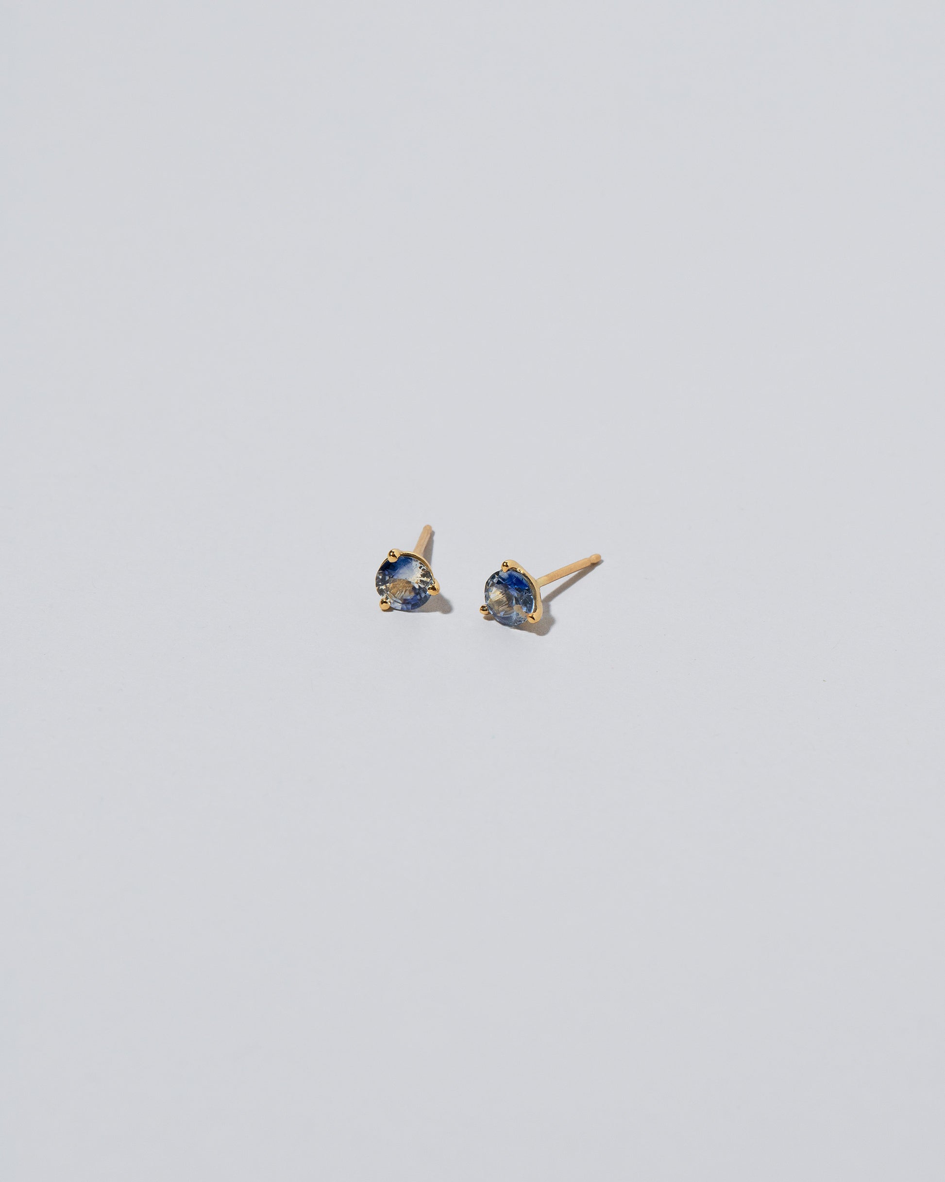 Martini Stud Earrings - Blue & White Sapphire on light color background.