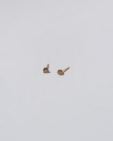 Cognac Diamond Martini Stud Earrings on light color background.