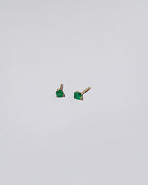 Emerald Martini Stud Earrings on light color background.