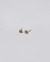 Green Bicolor Sapphire Martini Stud Earrings on light color background.