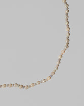 Closeup details of the Ula Pearl Necklace 004 on light color background.