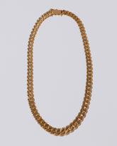 Tapered Flat Curb Chain Necklace on light color background,