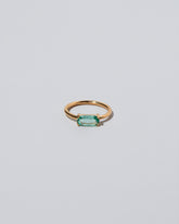 Green Adage Ring on light color background.
