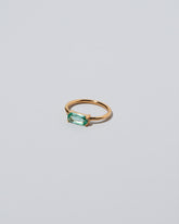 View from the side of the Green Adage Ring on light color background.