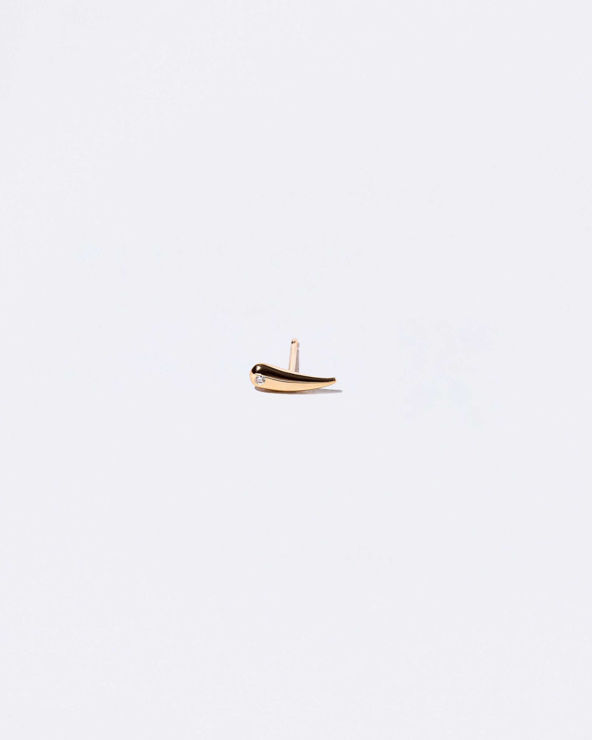 Gold White Diamond Right Facing One & Others Stud Earring Single on light color background.