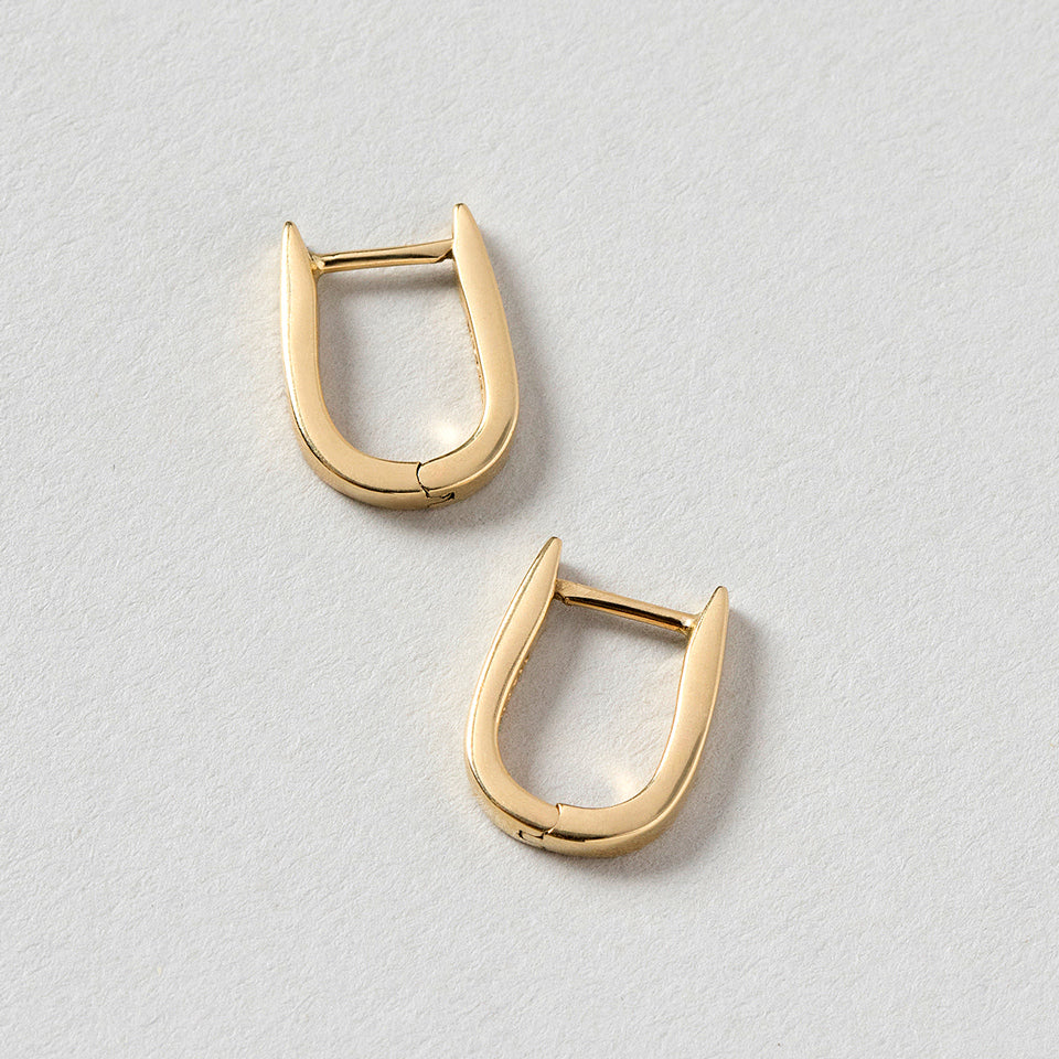 product_details::Poppy Flower Bud Hoops on light color background.