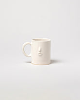 Rami Kim Face Mug on light color background.