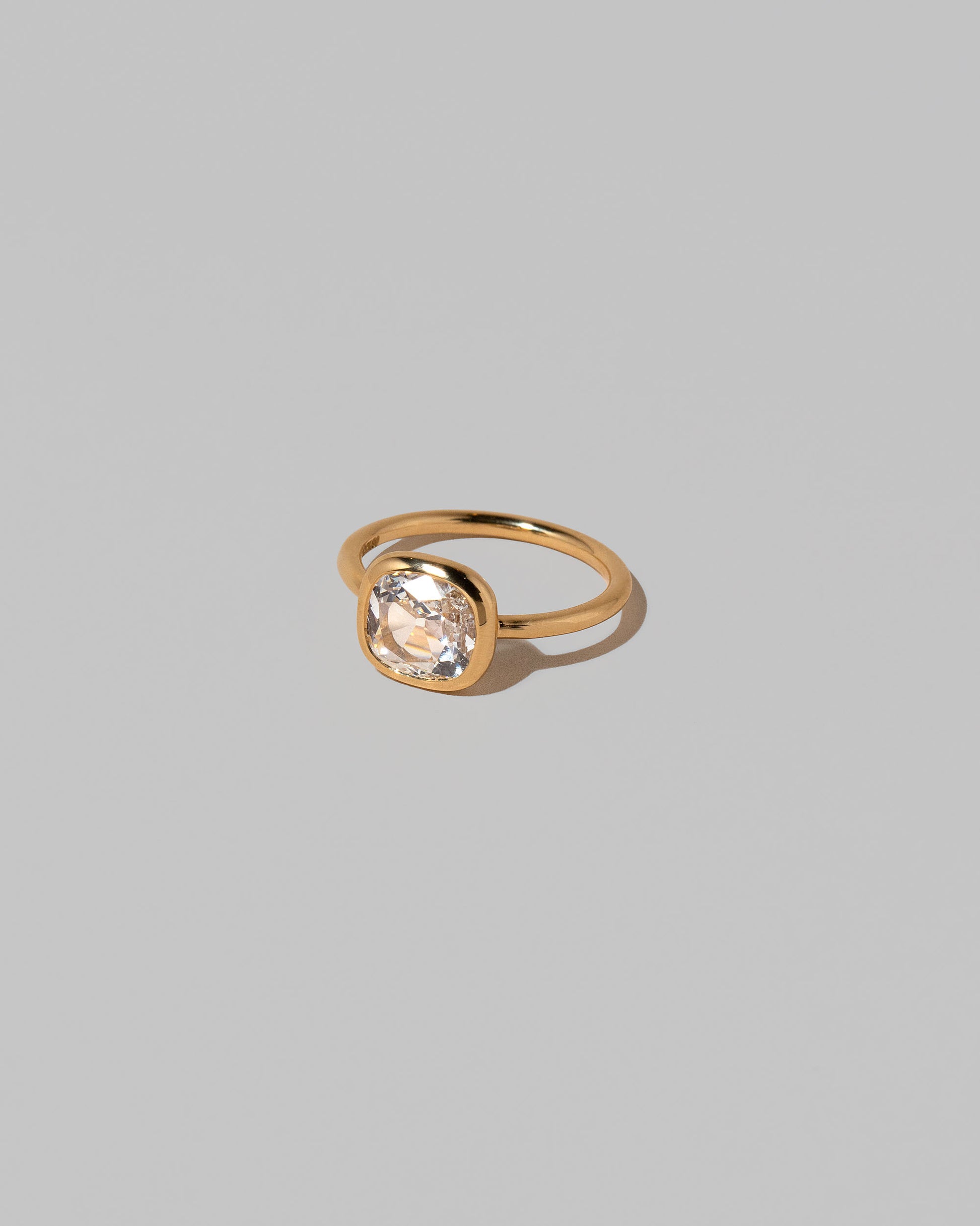 View from the side of the Gusher Diamond Ring 025 on light color background.