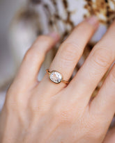 View from the side of the Cushion Diamond Gusher Ring on light color background.