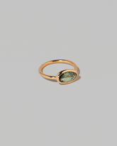 View from the side of the Gusher Green Sapphire Ring 002 on light color background.