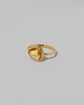 View from the side of the Gusher Yellow Sapphire Ring 035 on light color background.