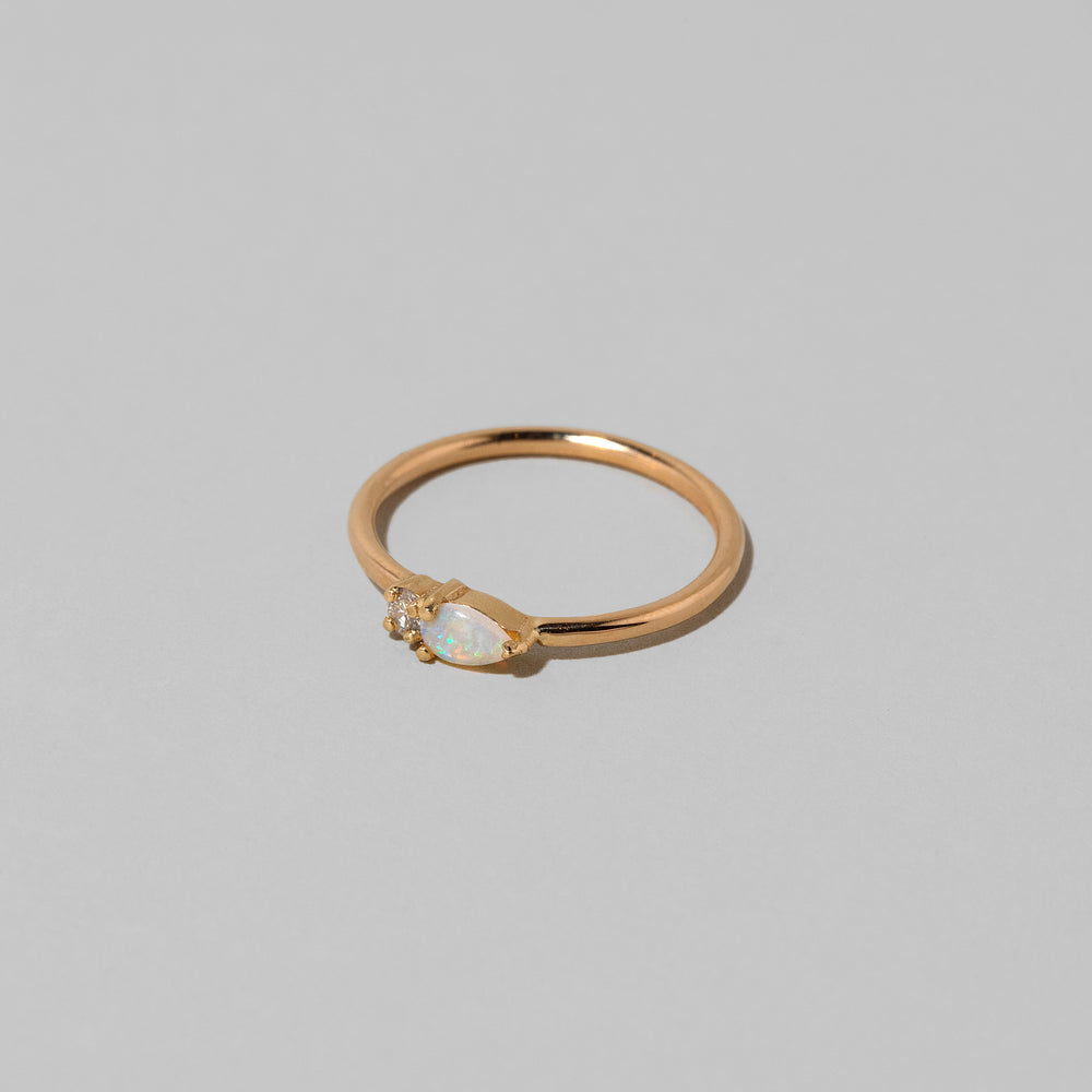 product_details::Closeup details of the Opal Teardrops Ring on light color background.