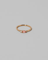 Peach Sapphire Teardrops Ring on light color background.