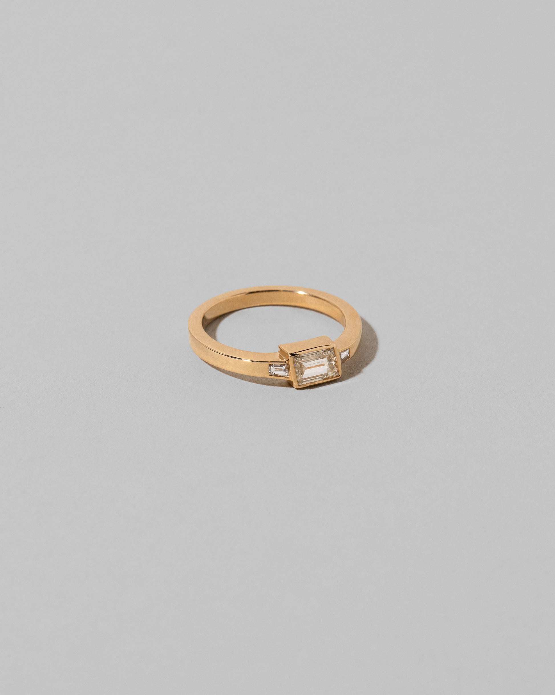 View from the side of the That Way Ring on light color background.