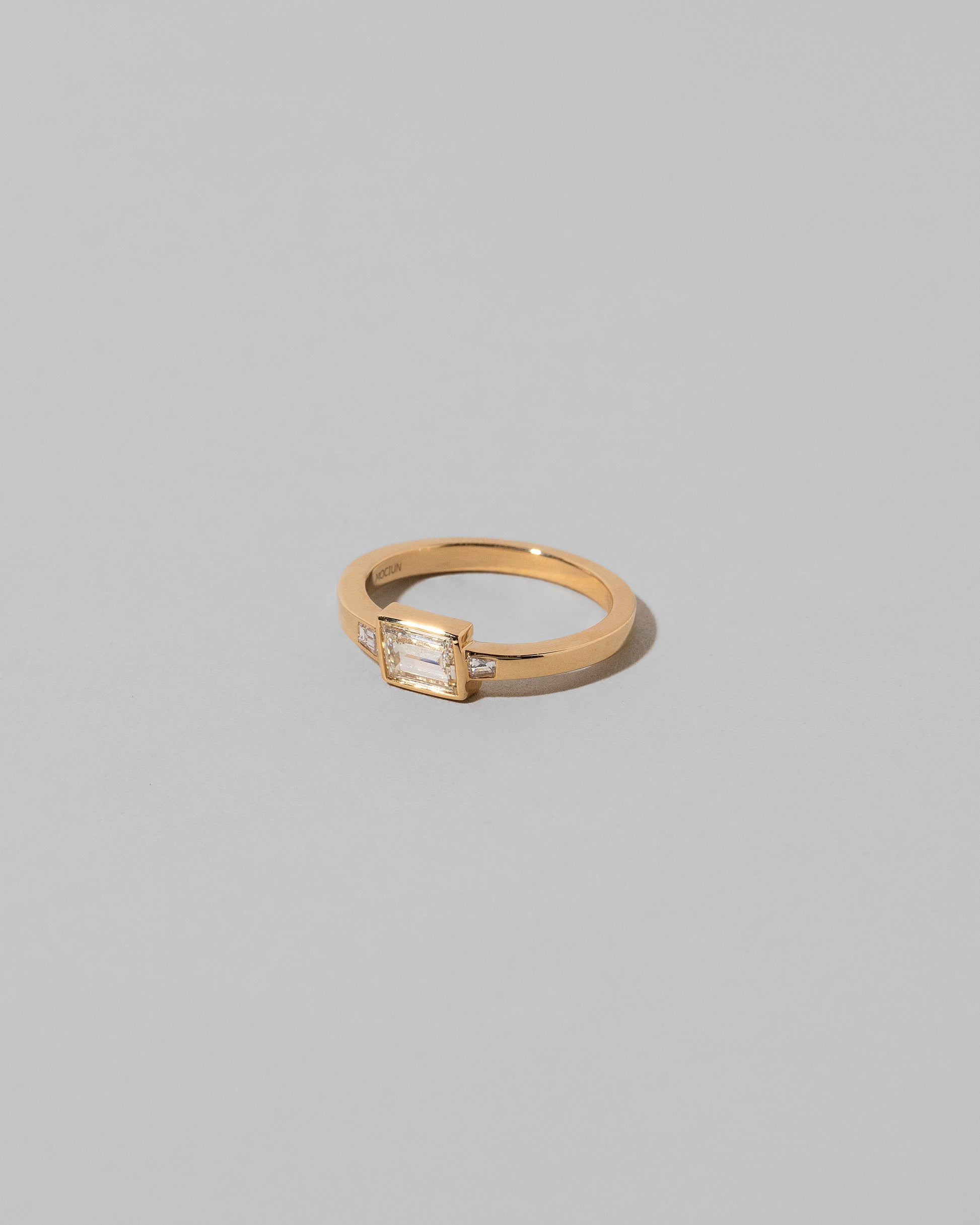 View from the side of the That Way Ring on light color background.