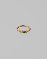 Tsavorite Teardrops Ring on light color background.