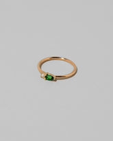 View from the side of the Tsavorite Teardrops Ring on light color background.