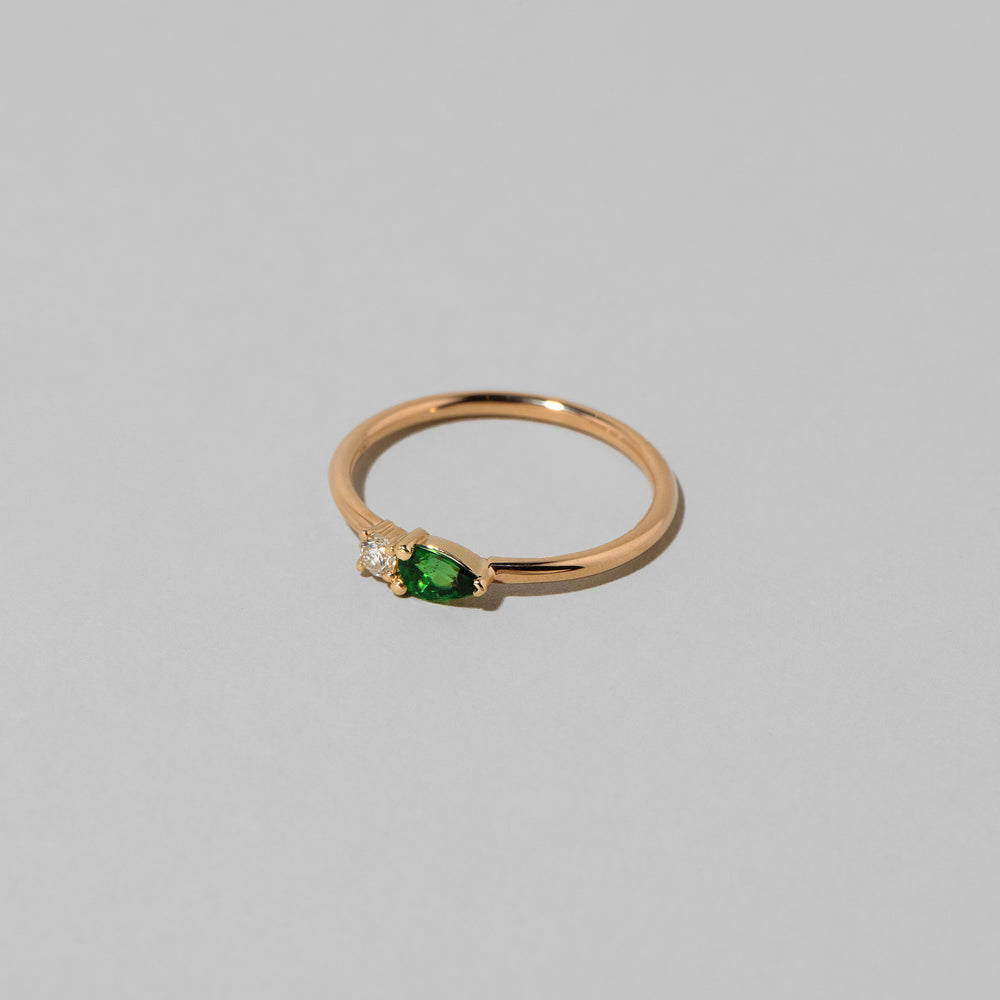 product_details::Closeup details of the Tsavorite Teardrops Ring on light color background.