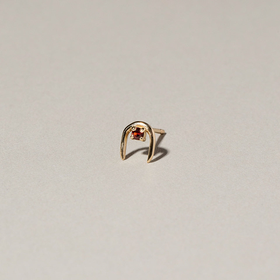 product_details::Garnet Moon Catcher Stud Earring Single on light color background.