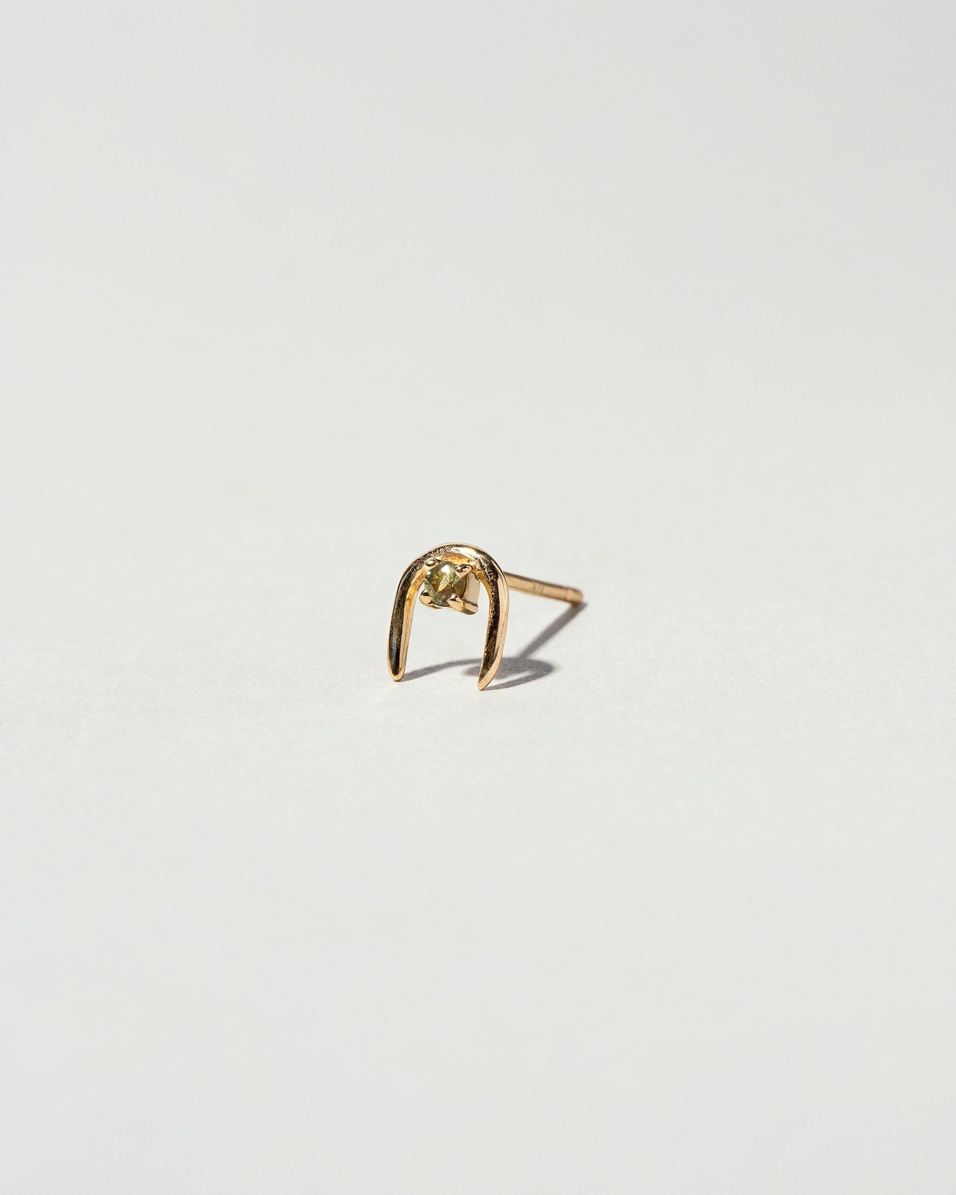 Peridot Moon Catcher Stud Earring Single on light color background.