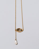 Pearl State Shifter Necklace on light color background.