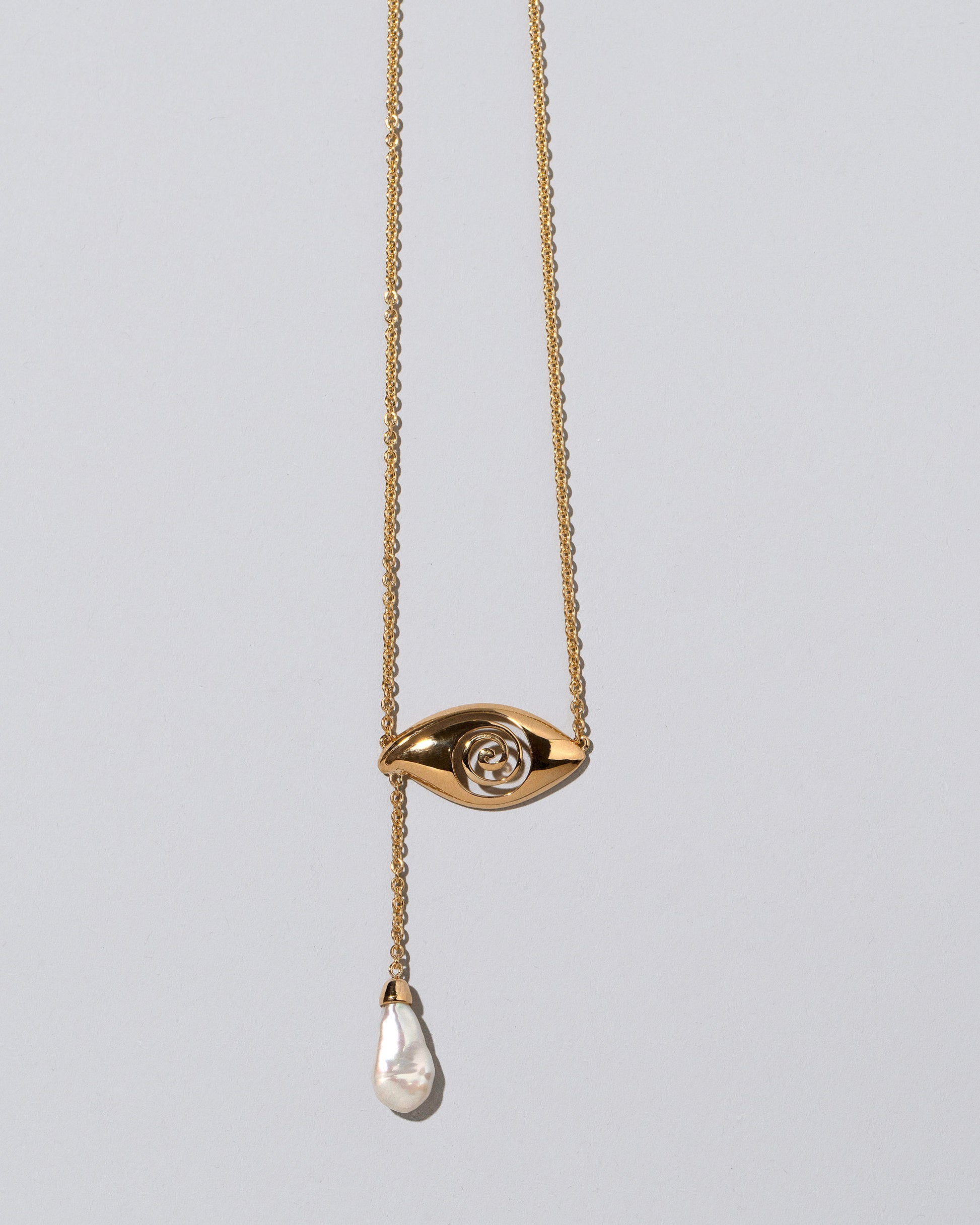 Pearl State Shifter Necklace on light color background.